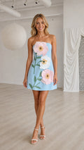Front view of light blue strapless mini dress with 3D floral appliques