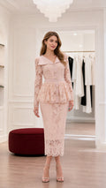 Front view of elegant pink lace peplum midi dress on model