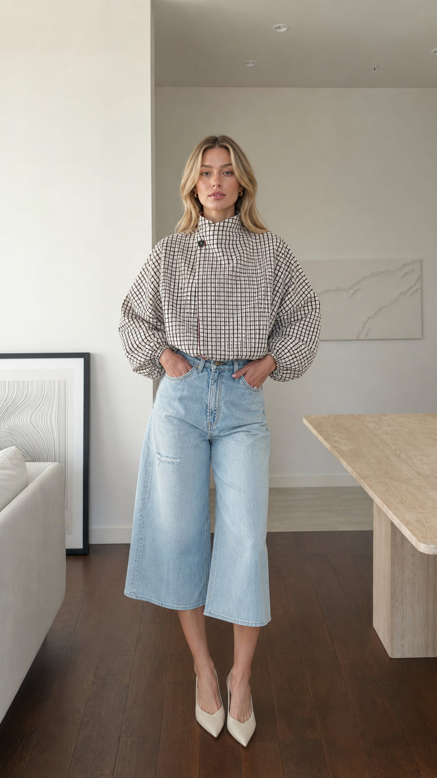 Model wearing white plaid high-neck blouse with light denim culottes from the front