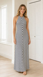 Front view of model wearing black and white striped halter maxi dress