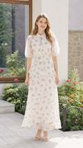 Front view of woman wearing off-white floral maxi dress