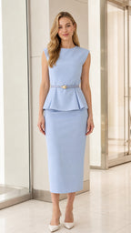 Model wearing light blue sleeveless peplum midi dress from the front