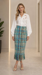 Front view of model wearing teal multi tweed fringe midi skirt with white blouse