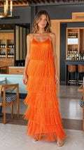 Front view of model wearing vibrant orange tiered fringe maxi slip dress