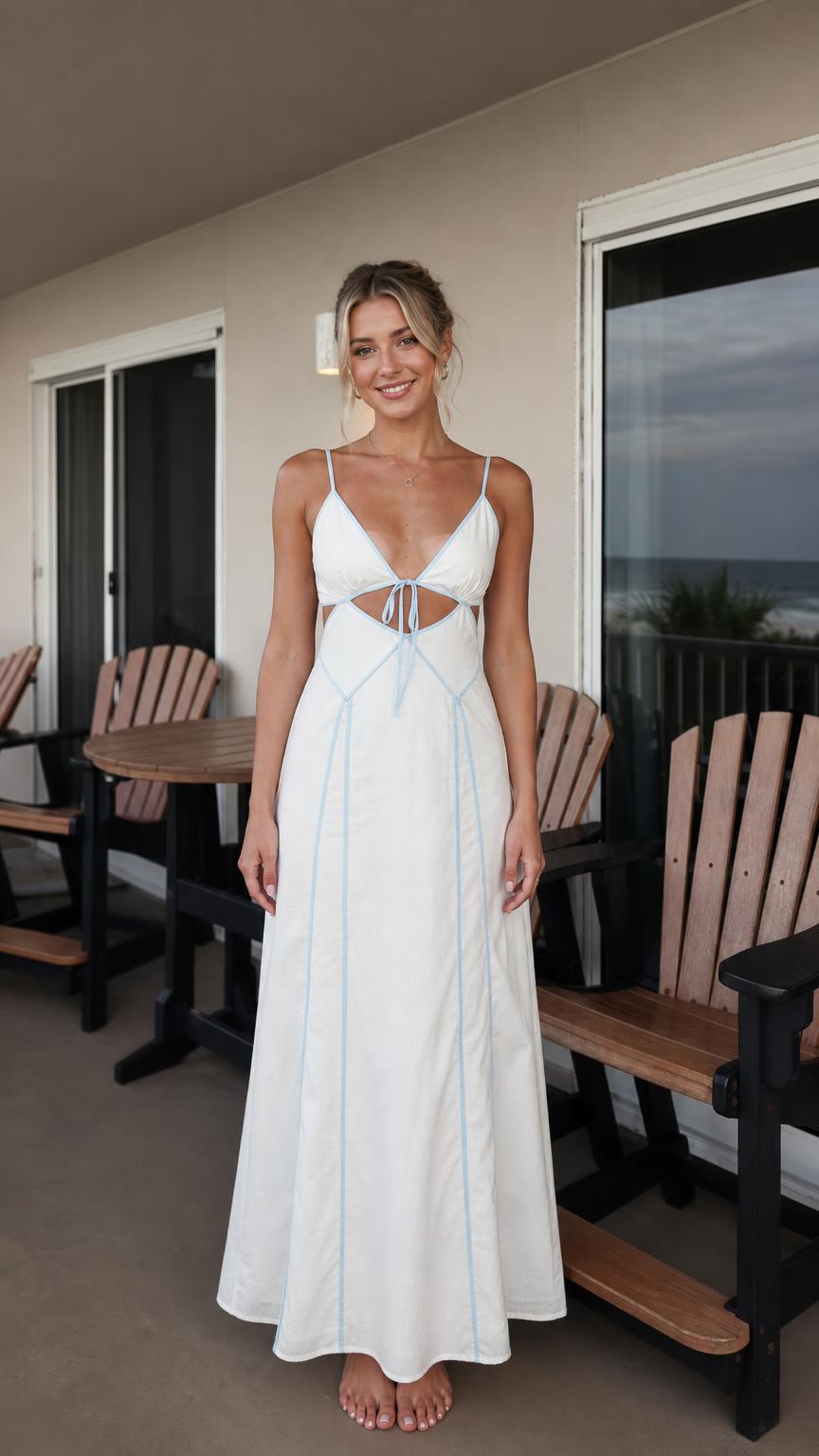 Front view of woman wearing white V-neck cutout maxi dress with blue piping