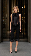 Front view of black avant-garde pleated fringe halter top and cropped pants set