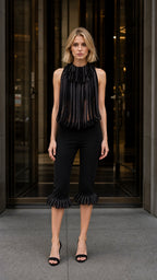Front view of black avant-garde pleated fringe halter top and cropped pants set