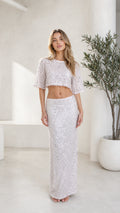 Front view of model wearing silver sequin crop top and maxi skirt set
