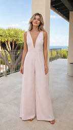 Front view of woman wearing blush pink wide leg formal jumpsuit