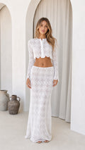 Front view of woman wearing white lace crop top and maxi skirt set