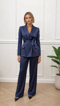 Front view of woman wearing navy satin blazer and wide-leg pants set