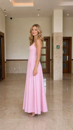 Side profile view of model wearing pink maxi dress