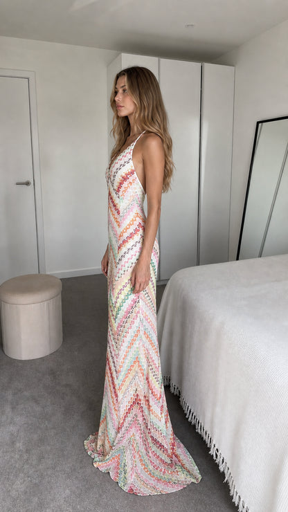 Side view of model wearing white chevron maxi dress