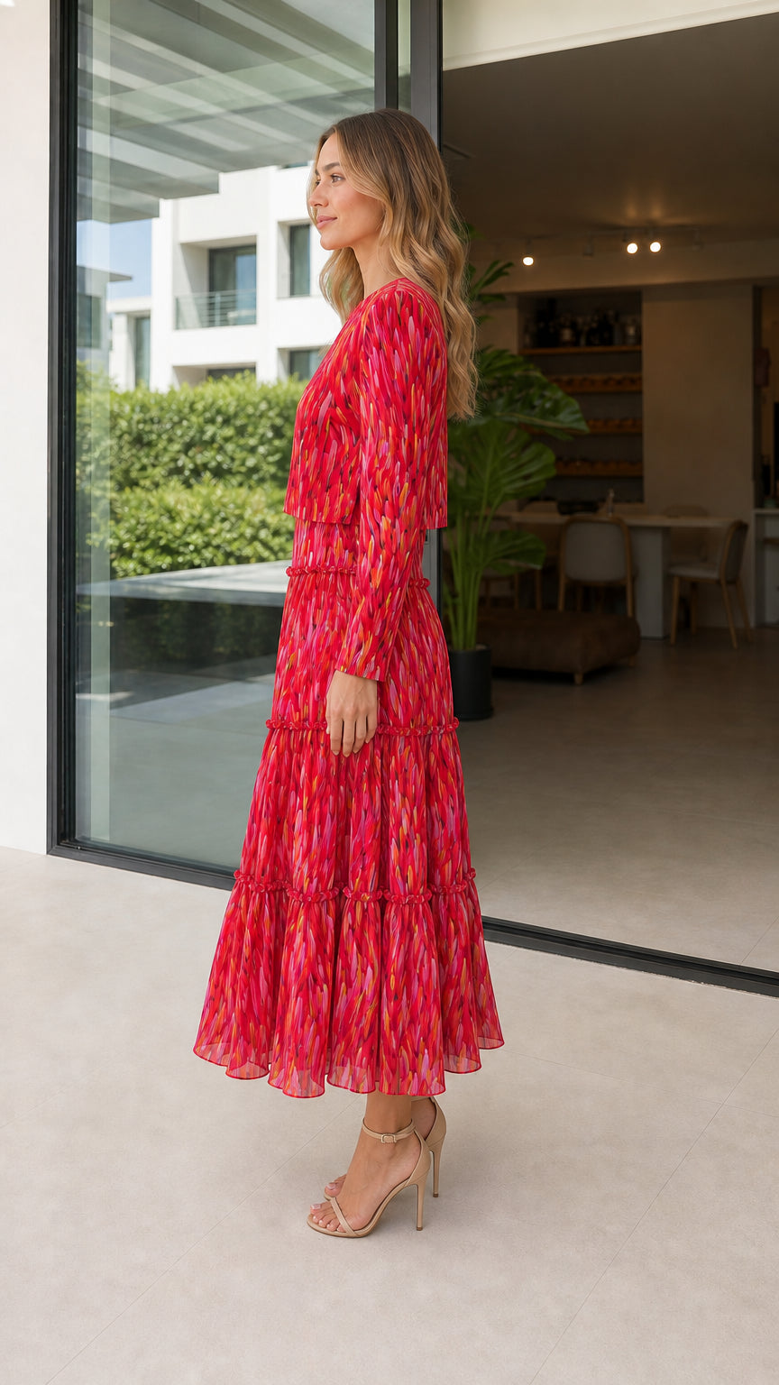 Side profile of model in red abstract print midi dress