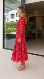 Side profile of model in red abstract print midi dress