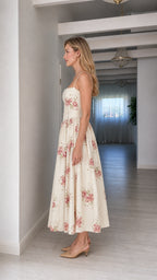 Side profile of woman wearing cream floral midi dress