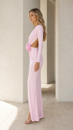 Side profile view of pink evening gown with waist cutout and rose detail