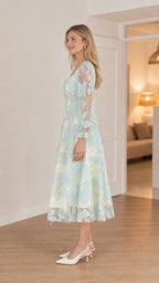 Side profile of model in mint midi dress
