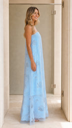 Model wearing light blue strapless sequin floral maxi dress side view