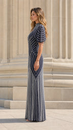 Model wearing navy beaded formal gown side profile