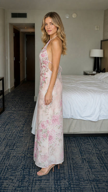 Side view of model wearing pink floral halter maxi dress