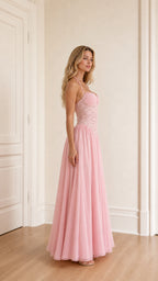 Model wearing pink evening dress side view