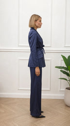 Side profile of woman wearing navy satin suit