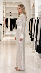 Side profile of model in silver sequin dress