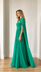 Side profile view of green cape gown