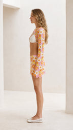 Side profile view of pink floral crochet two-piece outfit
