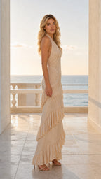 Side profile of model in champagne ruffle maxi dress