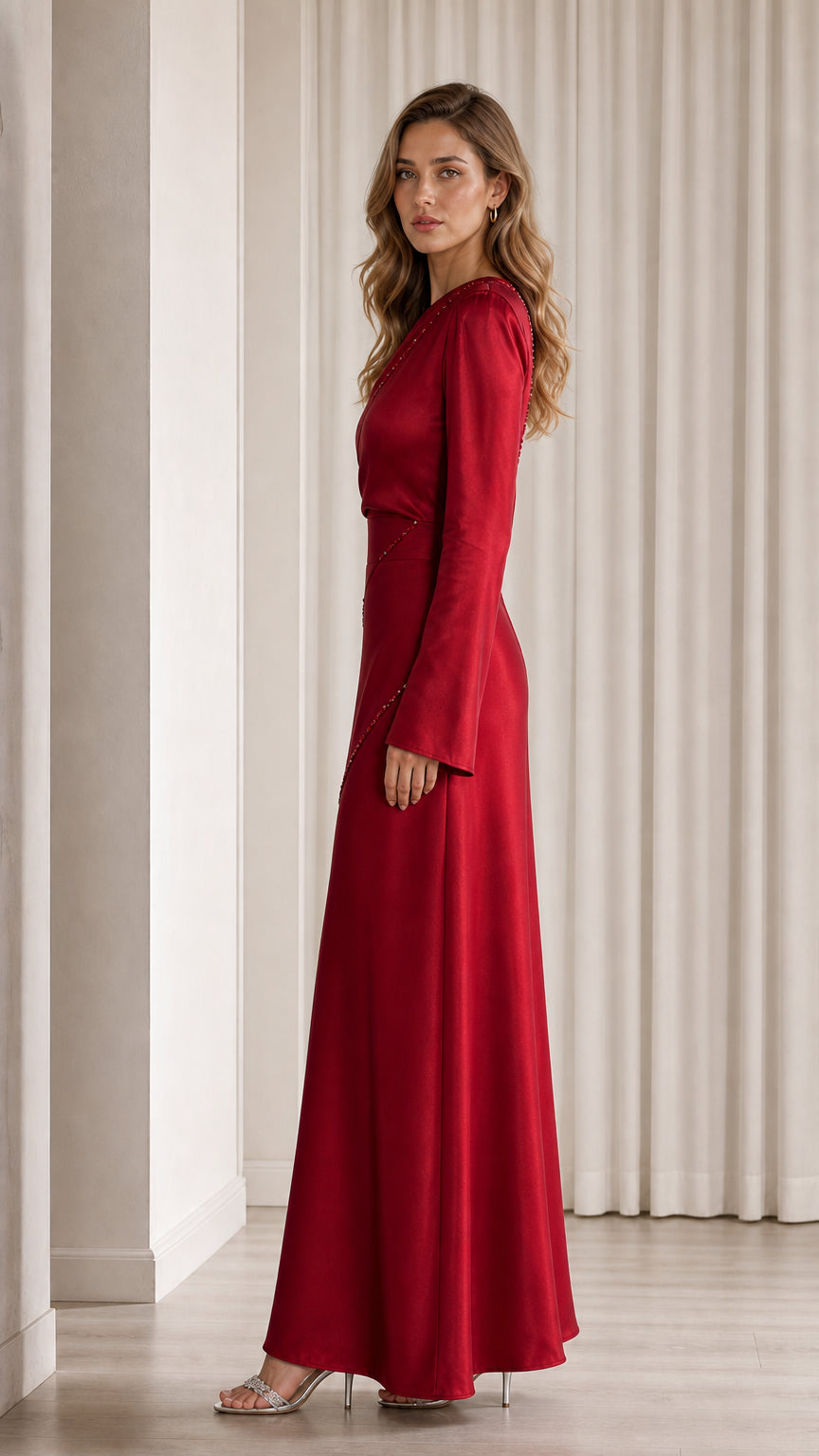 Side profile view of model in red satin gown