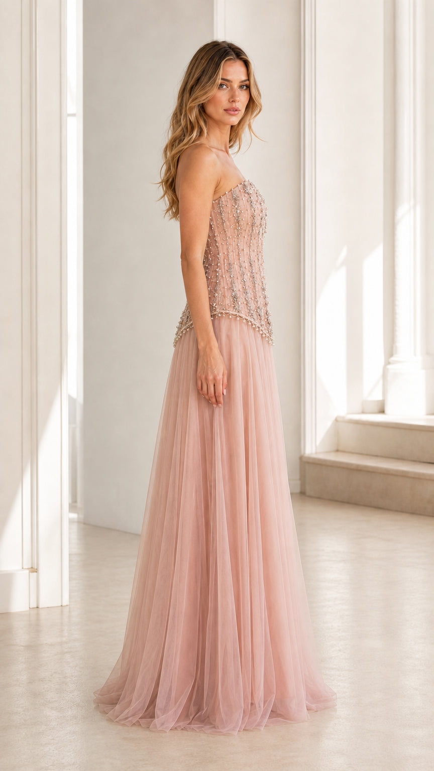 Side view of pink embellished strapless tulle evening gown