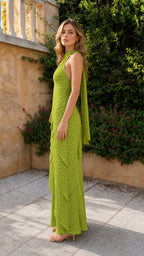 Side profile view of green halter maxi dress with cascading back ties