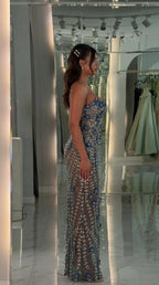 Side profile view of blue beaded evening gown