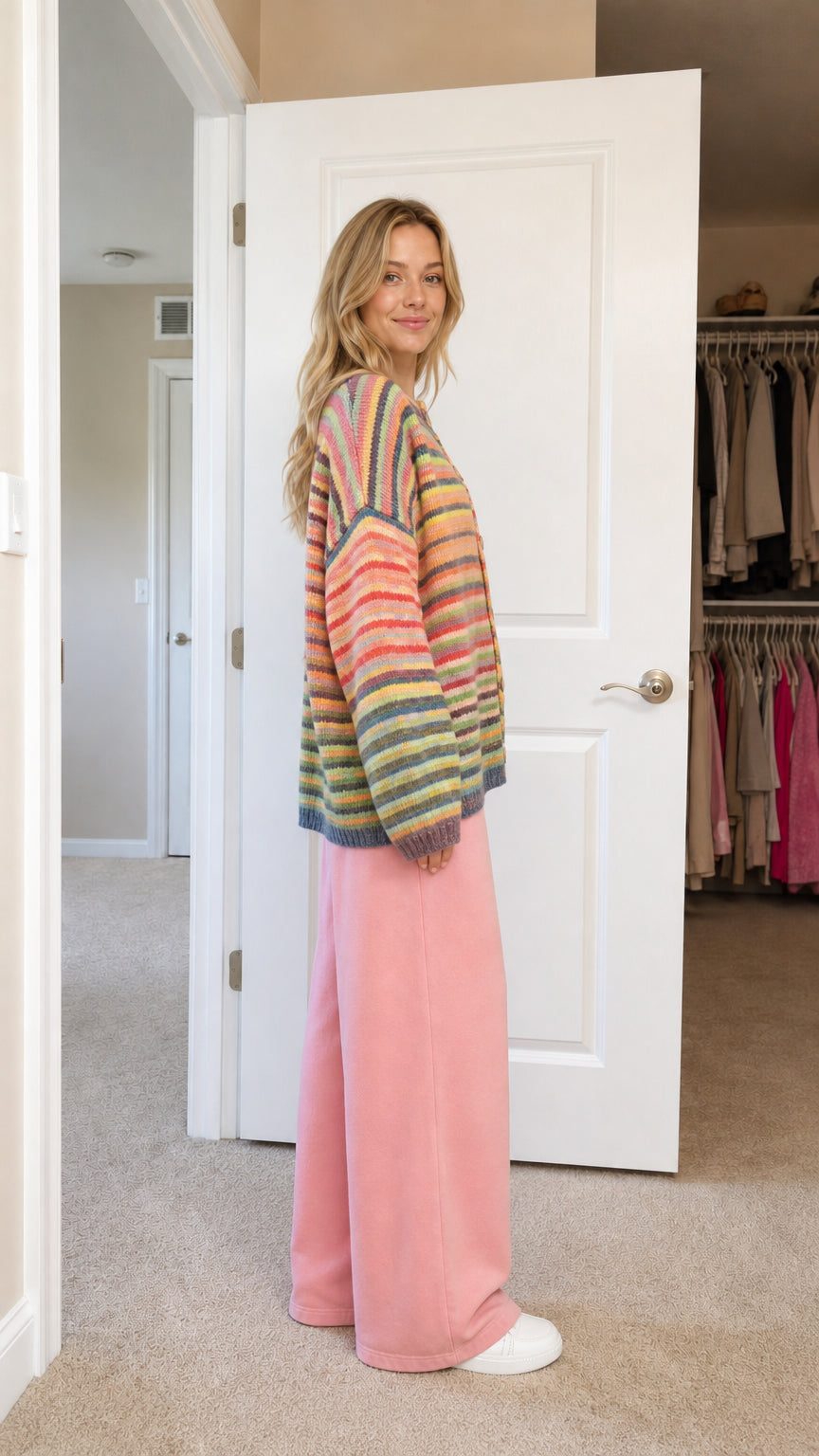 Side profile view of model in striped knit cardigan