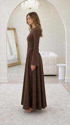 Side profile of model in brown maxi dress