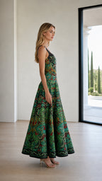 Side profile view of model in green patterned maxi dress