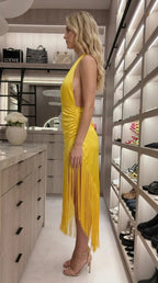 Side profile view of yellow satin fringe dress in luxury closet