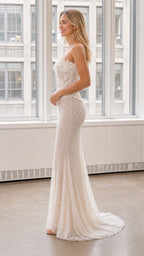 Side profile of white strapless lace evening gown with small train
