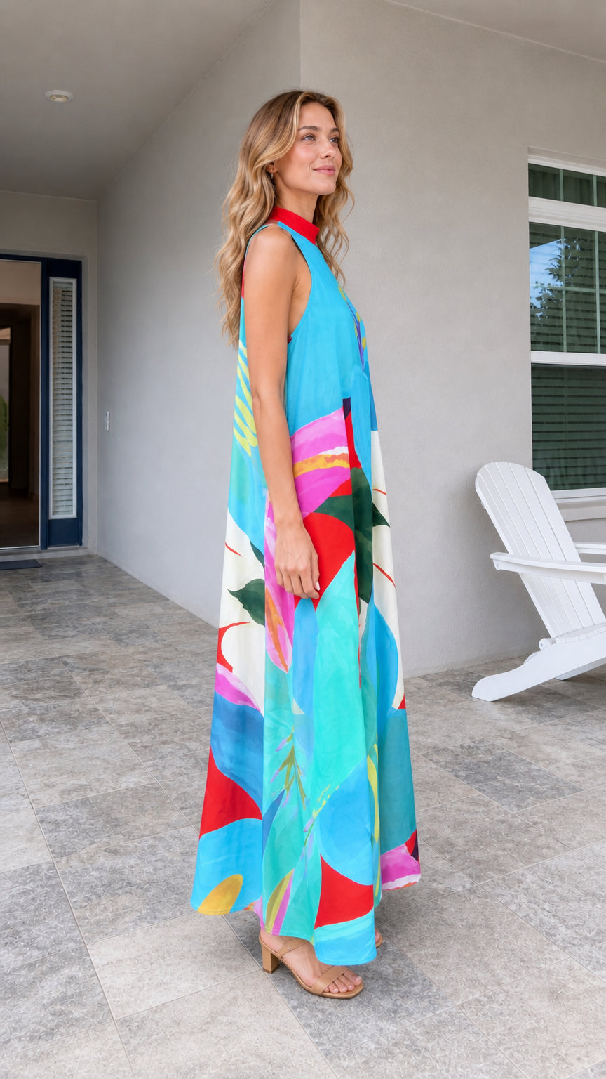 Side view of model wearing blue tropical print maxi dress