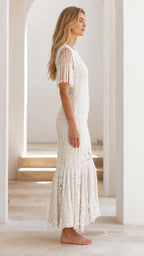 Side profile view of ivory crochet maxi dress