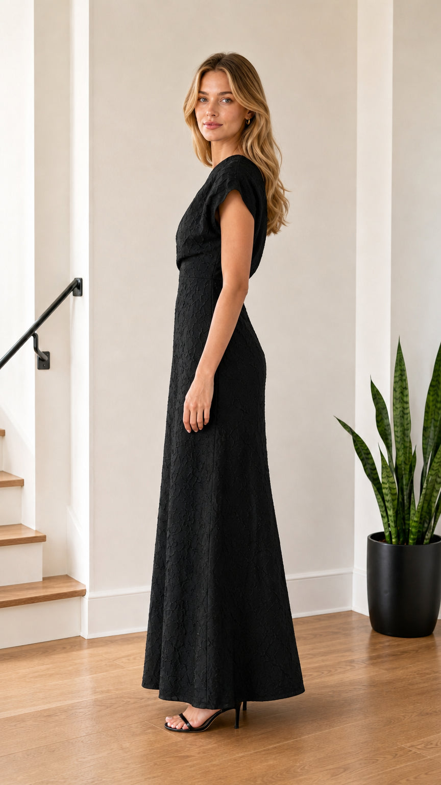 Model wearing Black one-shoulder maxi dress from side profile