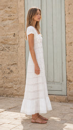 Side view of woman wearing white lace maxi dress