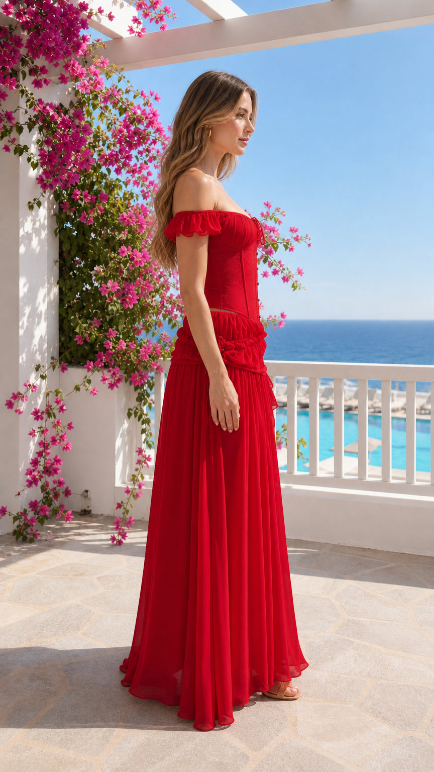 Side profile view of woman in red corset chiffon maxi dress