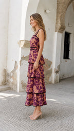 Side view of model wearing rose pink floral tiered midi dress