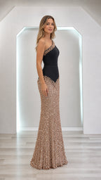 Model wearing black and gold one-shoulder sequin evening dress, side profile