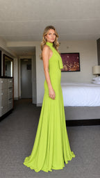 Model wearing lime green halter neck maxi dress from side profile