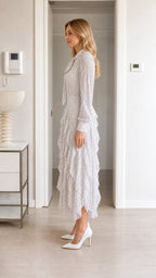 Side profile view of white polka dot midi dress