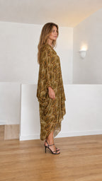 Model wearing olive paisley kaftan dress side view